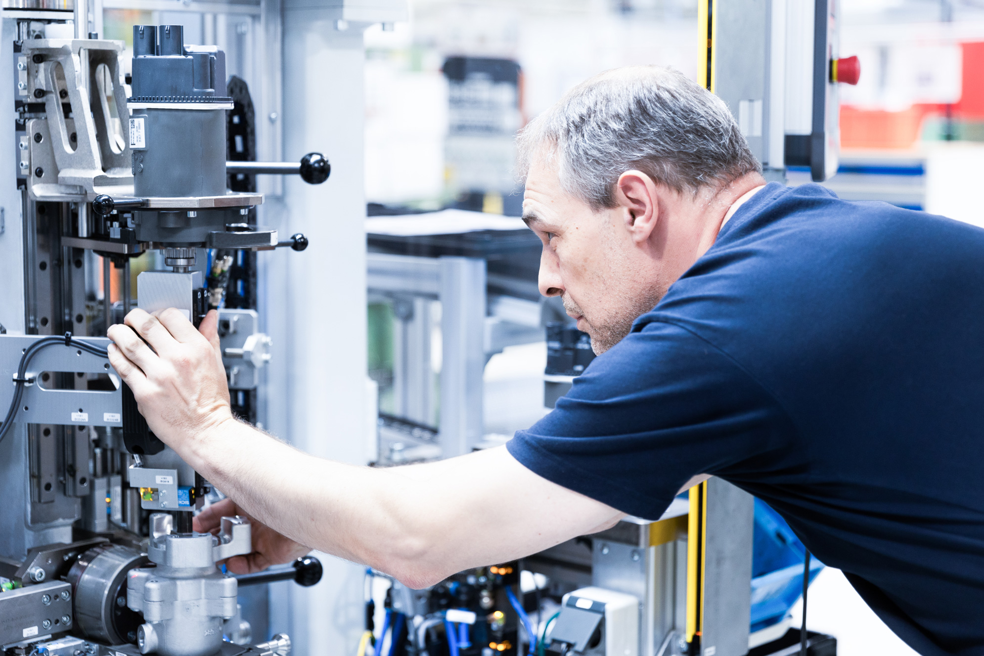 A specially trained expert performs a visual inspection on the assembly line of innovative power steering pumps.